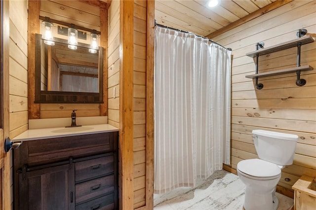 bathroom featuring vanity, toilet, curtained shower, and wooden walls