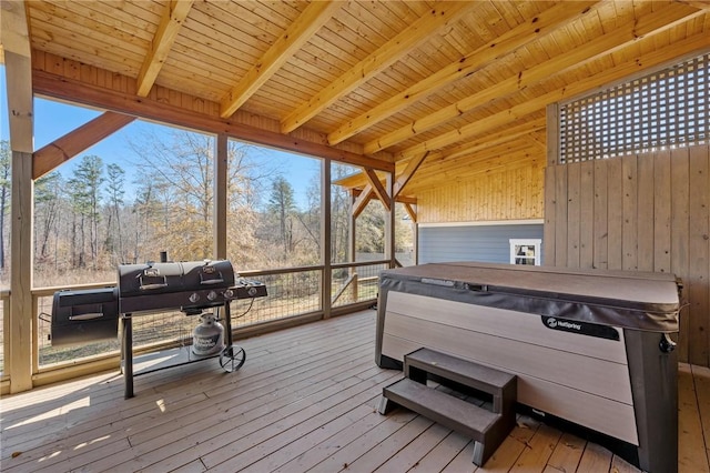 wooden deck featuring area for grilling and a hot tub