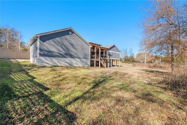 rear view of property with a yard and a wooden deck