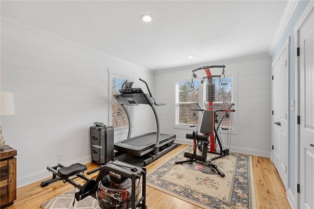 workout room with light hardwood / wood-style flooring and ornamental molding