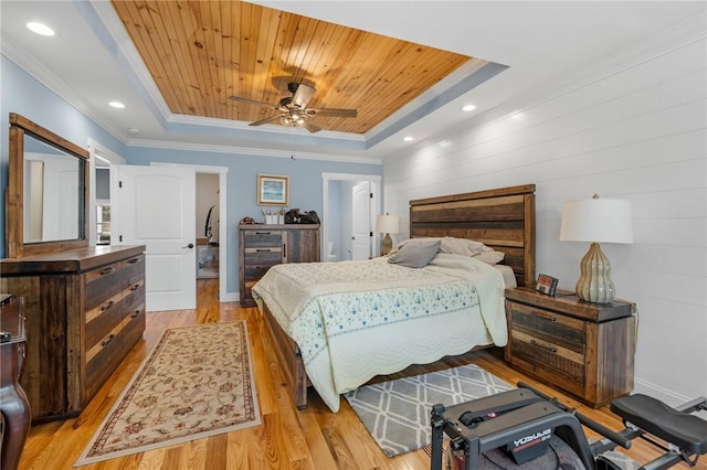 bedroom with a tray ceiling, ceiling fan, light hardwood / wood-style floors, and wooden ceiling