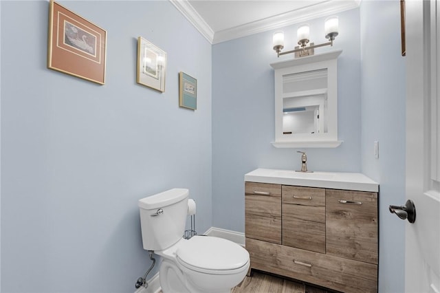 bathroom featuring vanity, toilet, ornamental molding, and wood-type flooring