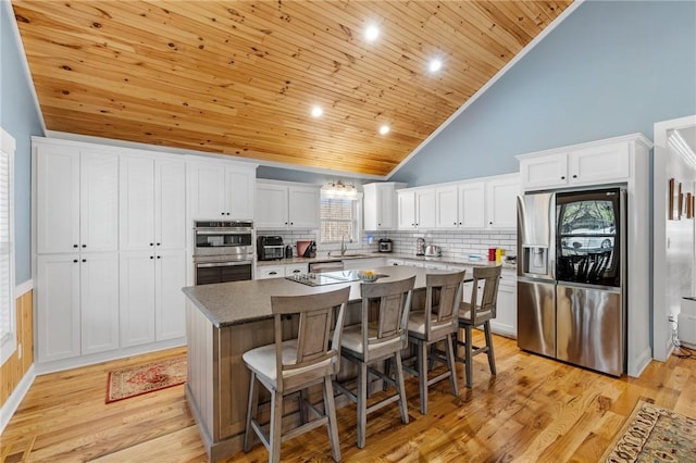 kitchen with white cabinetry, a kitchen island, and appliances with stainless steel finishes