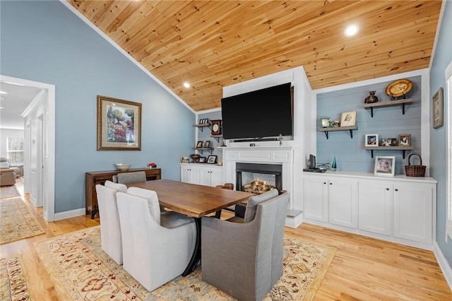 dining area with light hardwood / wood-style floors, lofted ceiling, crown molding, and wooden ceiling