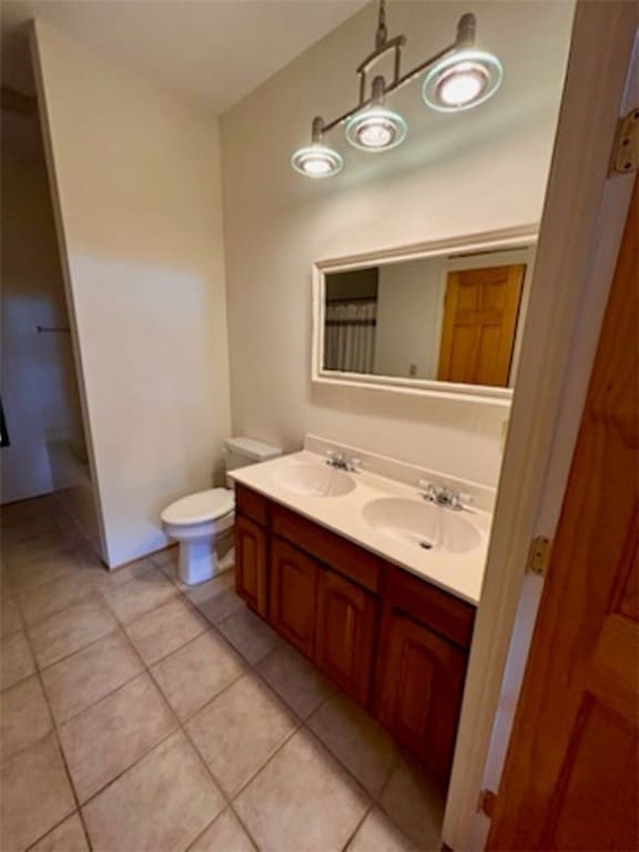 bathroom with tile patterned floors, vanity, and toilet