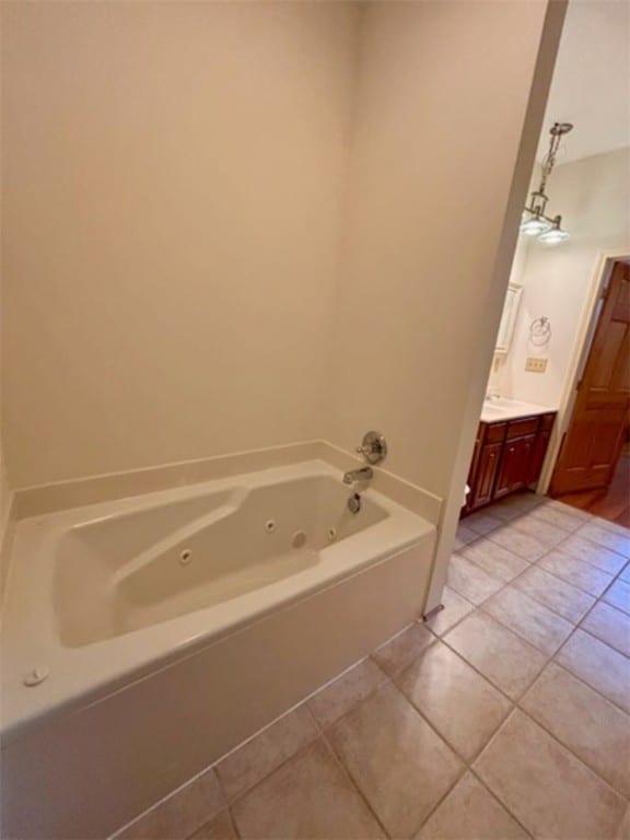 bathroom featuring a bath, vanity, and tile patterned floors