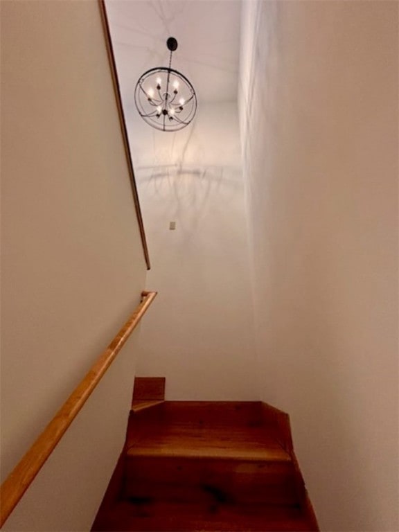 stairs with an inviting chandelier