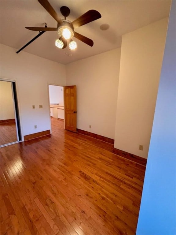 unfurnished room with ceiling fan and hardwood / wood-style floors