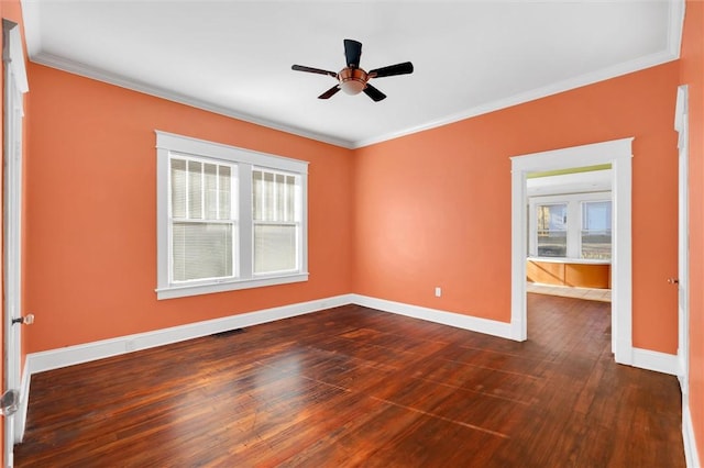 spare room featuring ceiling fan, crown molding, and dark wood-type flooring