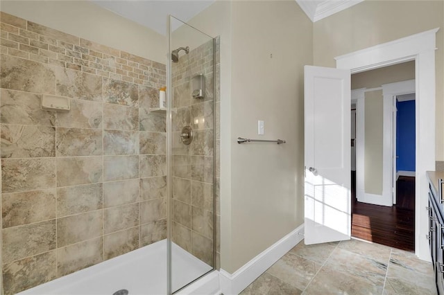 bathroom featuring tiled shower, vanity, hardwood / wood-style flooring, and crown molding