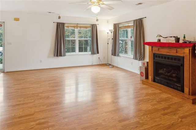 unfurnished living room featuring ceiling fan and light hardwood / wood-style flooring