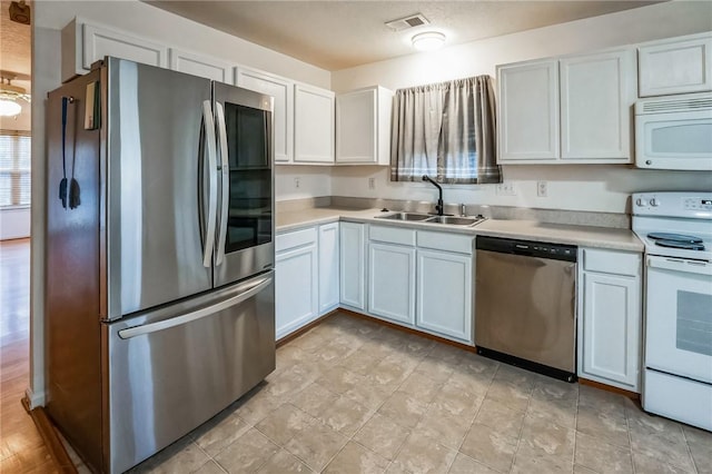 kitchen with white cabinets, stainless steel appliances, and sink