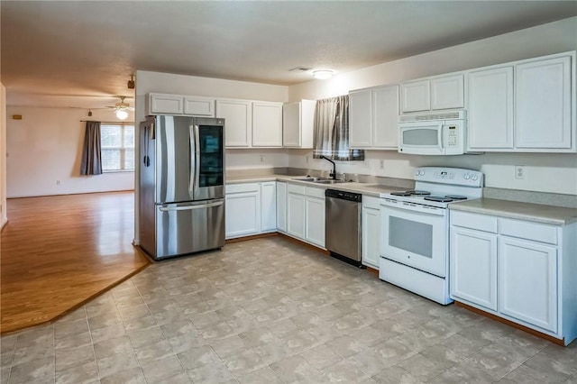 kitchen featuring white cabinets, sink, light hardwood / wood-style flooring, ceiling fan, and appliances with stainless steel finishes