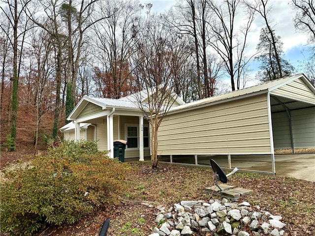 view of property exterior with a carport