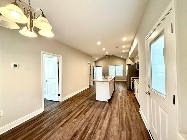 kitchen featuring dark hardwood / wood-style floors, a kitchen island, lofted ceiling, and sink