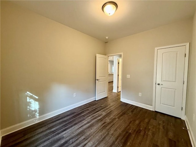 unfurnished bedroom with dark wood-type flooring