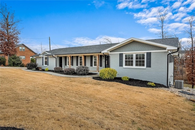 ranch-style house with a front yard and central AC