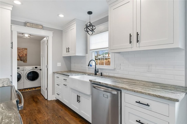 kitchen featuring dishwasher, white cabinets, hanging light fixtures, washer and dryer, and dark hardwood / wood-style flooring