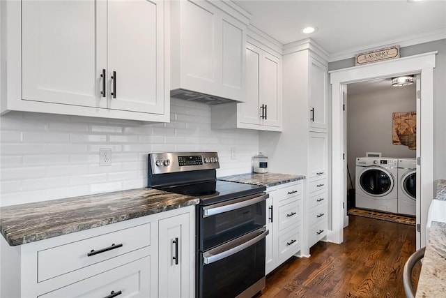 kitchen with electric range, white cabinetry, dark stone countertops, and independent washer and dryer