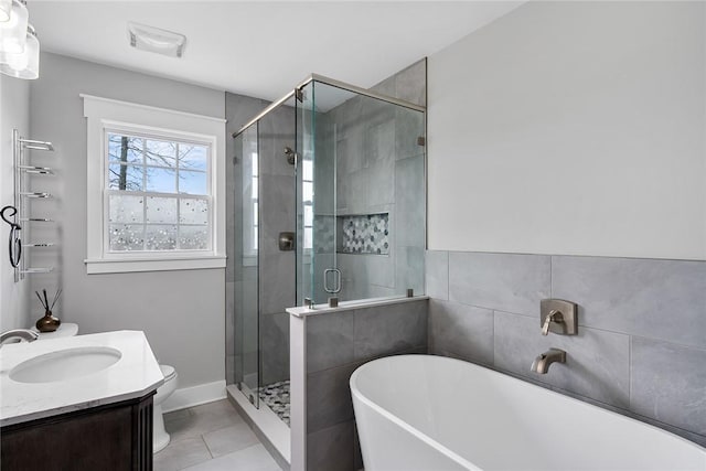 full bathroom featuring tile patterned floors, vanity, separate shower and tub, and toilet