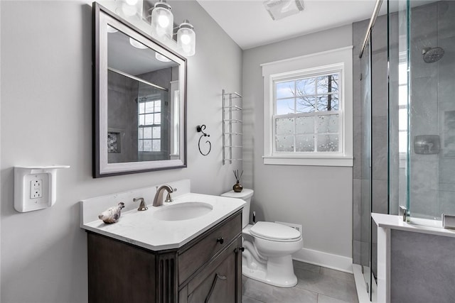 bathroom with tile patterned floors, vanity, an enclosed shower, and toilet