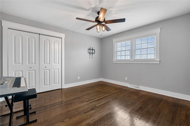 office space with ceiling fan and dark hardwood / wood-style floors