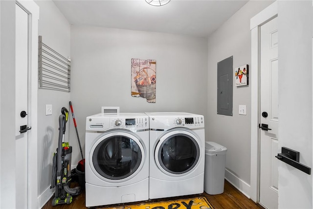 laundry room featuring washer and clothes dryer, dark hardwood / wood-style floors, and electric panel