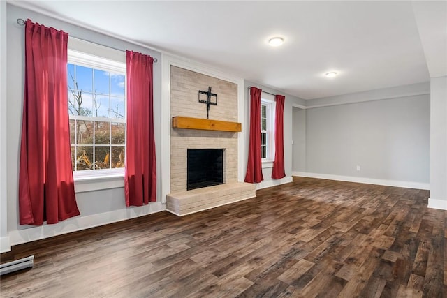 unfurnished living room with dark hardwood / wood-style flooring, a fireplace, and a baseboard radiator