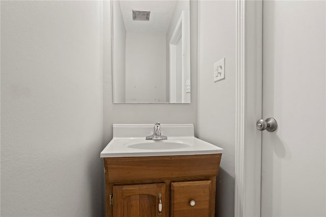 bathroom featuring a textured ceiling and vanity