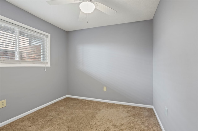 unfurnished room with carpet and ceiling fan