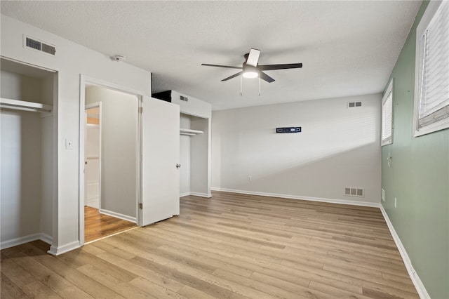 unfurnished bedroom featuring a textured ceiling, light hardwood / wood-style flooring, and ceiling fan