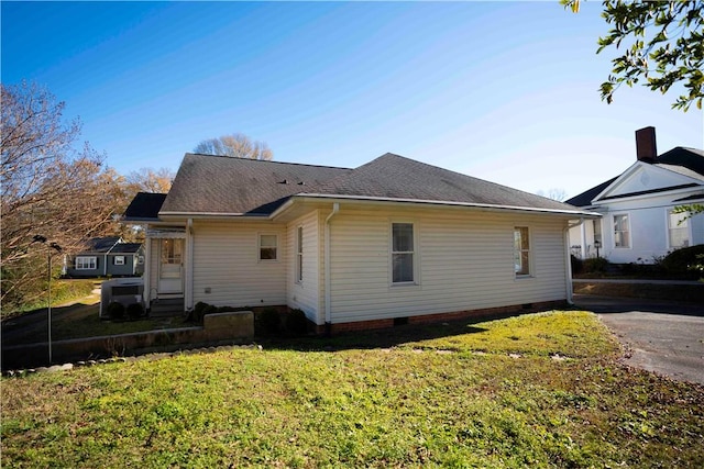 view of side of home with a lawn