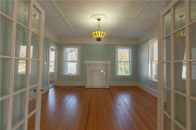 interior space with wood-type flooring and ornamental molding