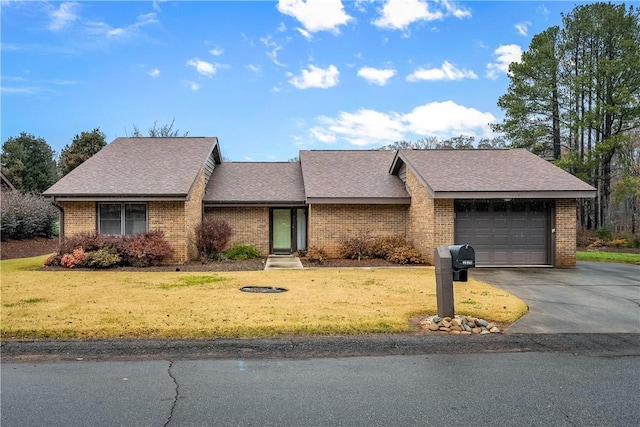 single story home featuring a garage and a front lawn