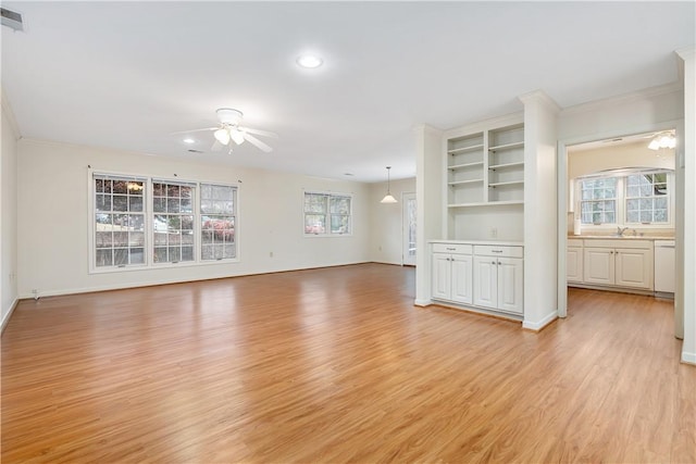 unfurnished living room with light hardwood / wood-style flooring, ceiling fan, ornamental molding, and sink