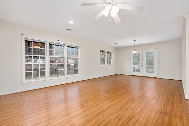 spare room with ceiling fan, french doors, ornamental molding, and light wood-type flooring