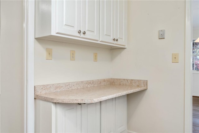 kitchen featuring white cabinetry and wood-type flooring