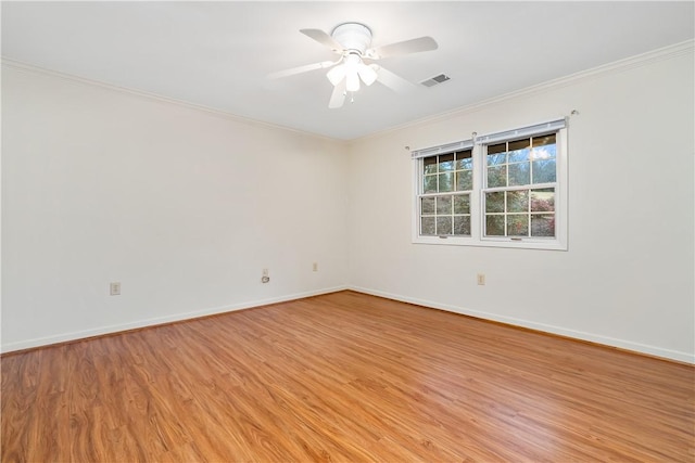 empty room featuring ceiling fan, light hardwood / wood-style floors, and ornamental molding