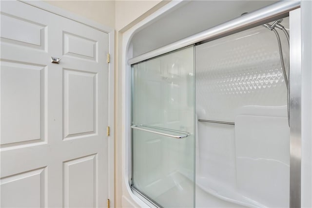 bathroom with a shower with door