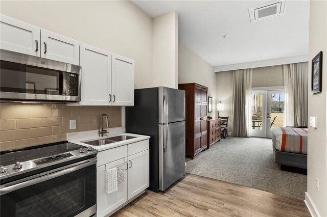 13500 Clemson Blvd Unit 2108, Seneca, SC 29678 - kitchen with white cabinetry, sink, light hardwood / wood-style floors, and appliances with stainless steel finishes