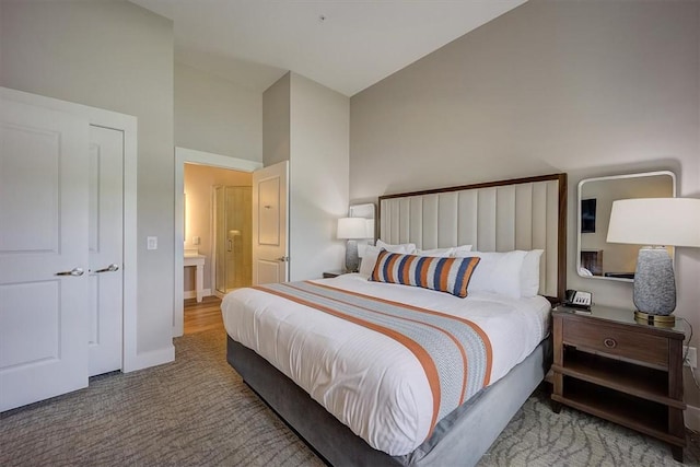 carpeted bedroom featuring high vaulted ceiling