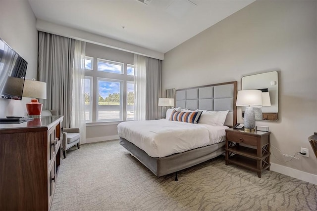 carpeted bedroom with vaulted ceiling