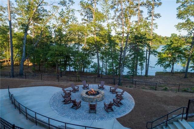 view of yard with a patio area, a water view, and an outdoor fire pit