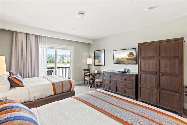 bedroom with access to outside and light colored carpet