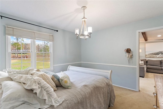 carpeted bedroom featuring a notable chandelier