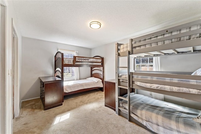 carpeted bedroom featuring a textured ceiling