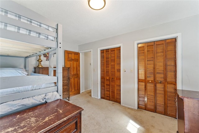 carpeted bedroom with two closets