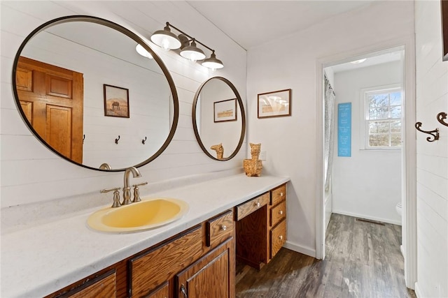 bathroom featuring shower / bath combo, vanity, and hardwood / wood-style flooring