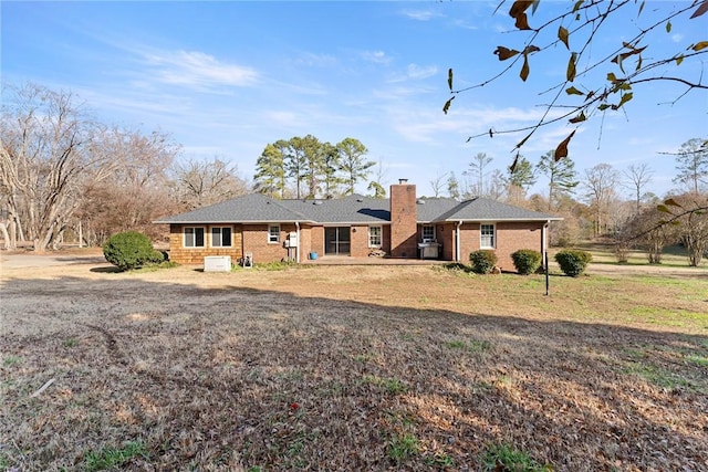 back of house with a lawn