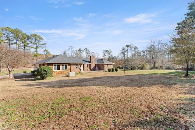 rear view of house with a lawn